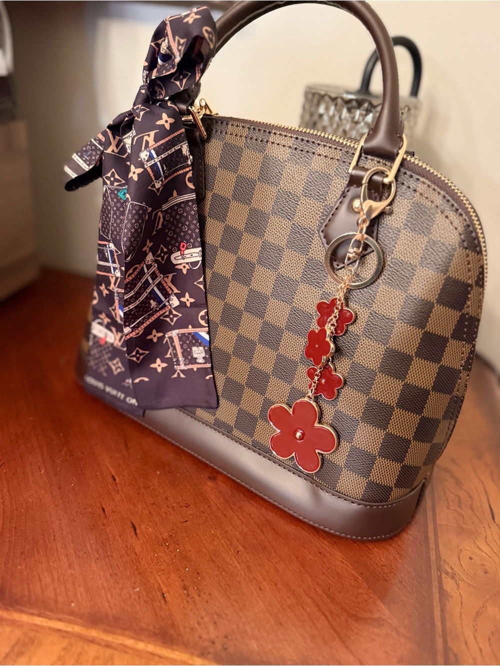 Source Unknown Brown Checkered Satchel with Red Flower Charm.